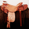 Vaquera Wade (Cowgirl Wade) with Sheridan Style Floral tooling, 15 and 1/2 inch seat, Gullet - 7 and 1/2 inch by 6 and 1/4 inch by 4 inch, Horn  3 X 4 inch round, 90 degree bars, 7/8ths In skirt riggin, 1 and 1/4 inch Cheyenne Roll, Sheridan Styl Floral with Vaquero border half breed combination.  Cowgirl Tough!!  Contact us about a saddle made just for you like this one.
